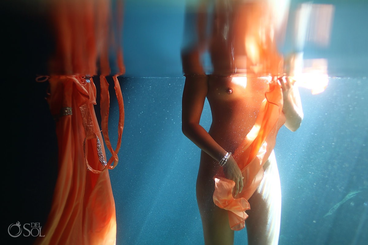 Bride totally naked underwater with bare nipples showing in island outfitter dress