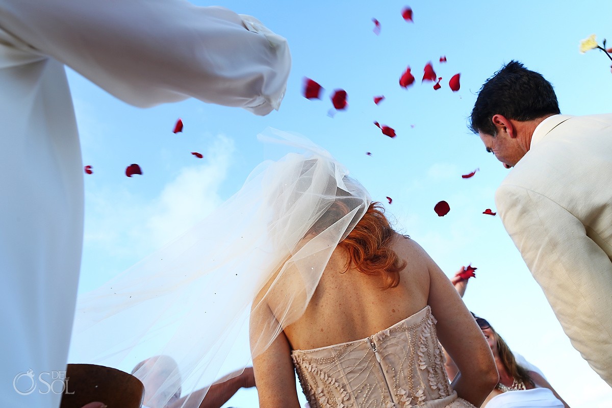 throwing rose petals Beach Cosmic wedding ceremony, Belmond Maroma Riviera Maya, Mexico