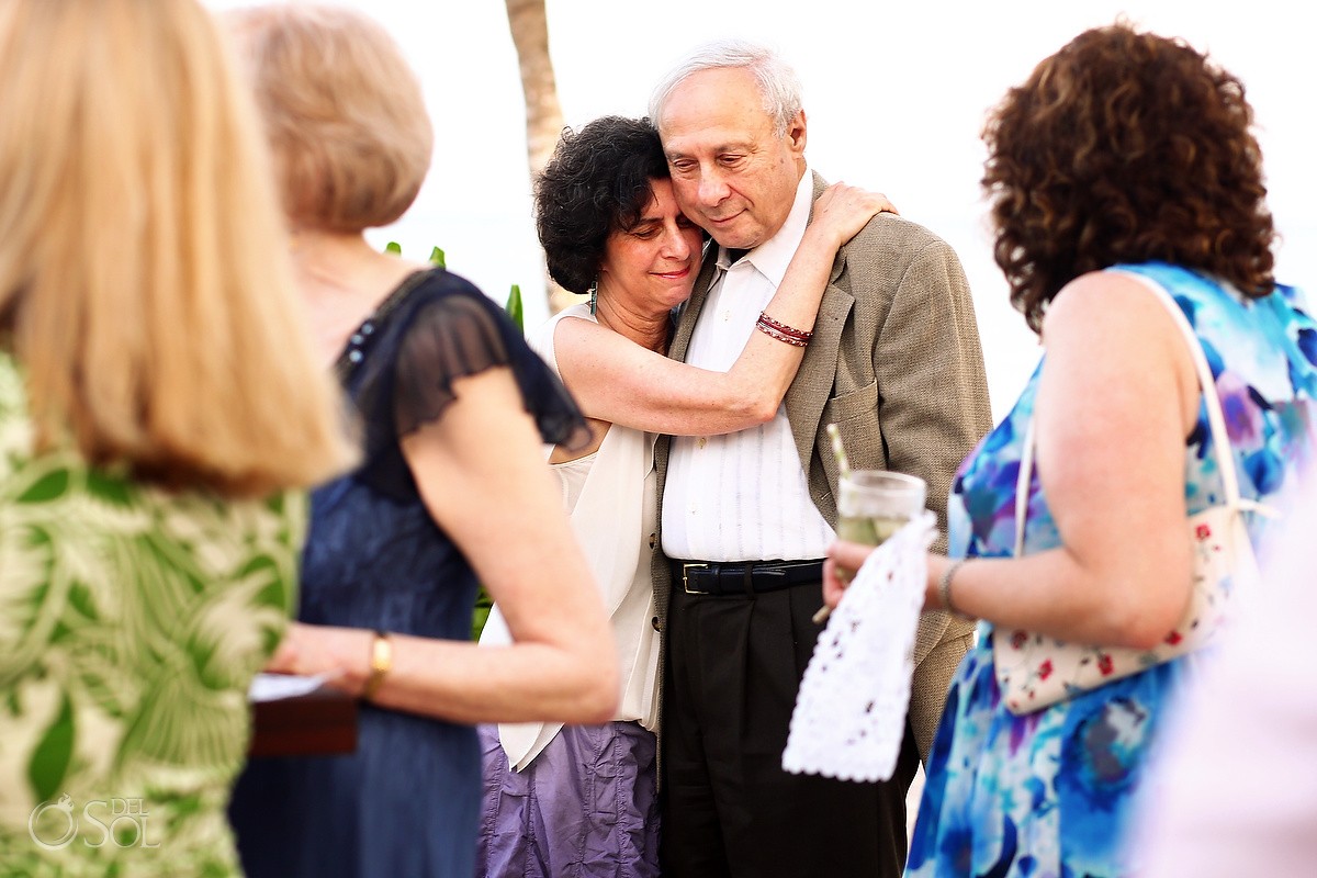Emotional wedding guests at a beach wedding in the Riviera Maya