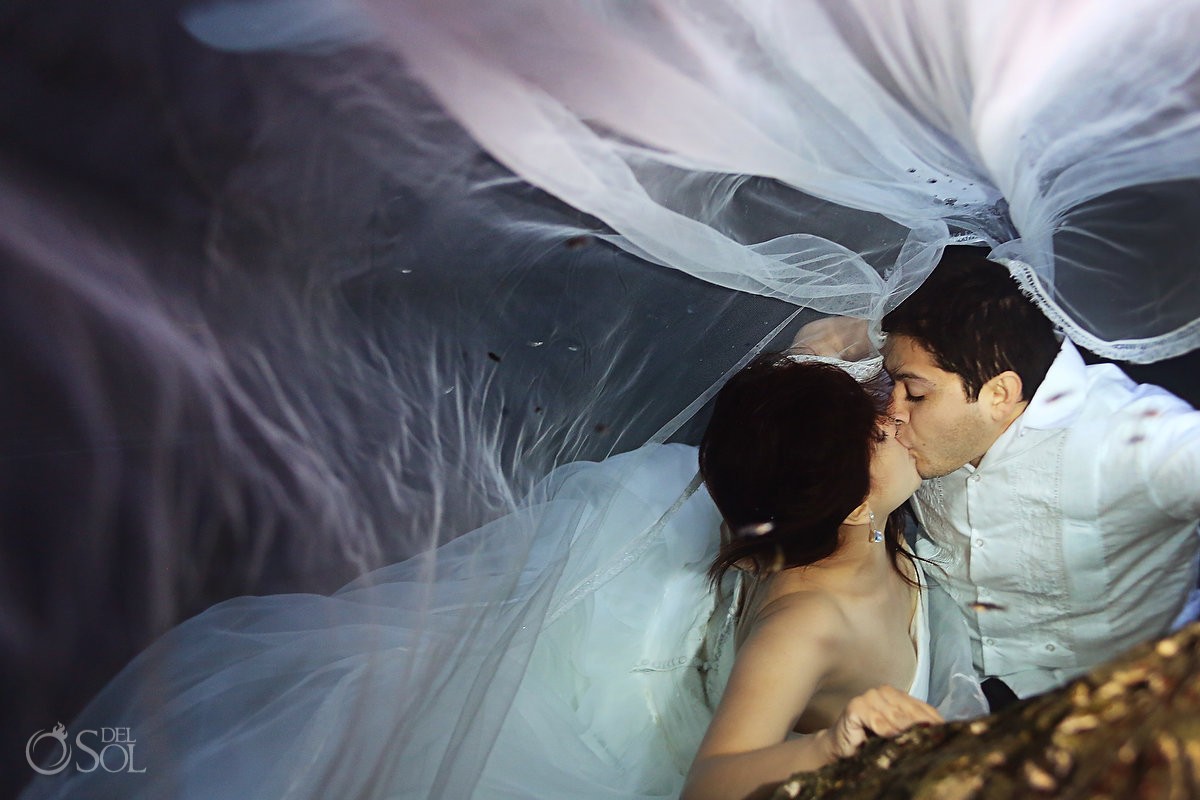 Underwater bride and groom in a cenote in the Riviera Maya trash the dress shoot