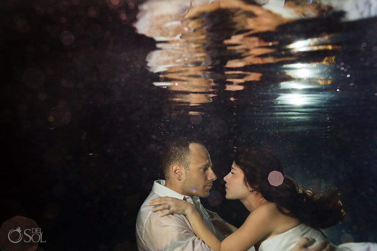Underwater bride and groom in a cenote trash the dress photo shoot