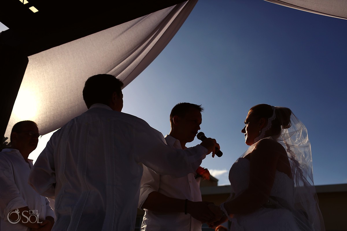 Beach wedding ceremony exchanging vows
