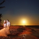 Bride and groom on the beach under moonlight at dreams tulum hotel