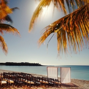 Hotel Esencia weddings beach ceremony location with chairs under full moonlight