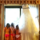 three flowergirls stand next to bridal gown at barcelo mayan palace