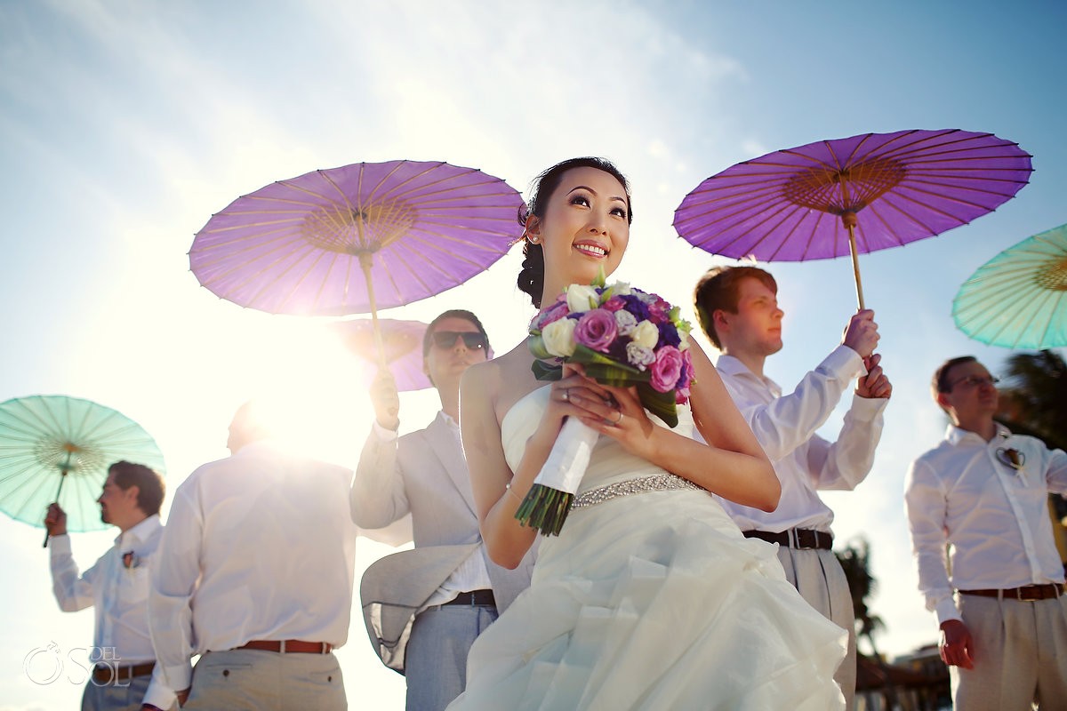 Parasols at a beach wedding Chinese bride