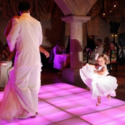 flowergirl dancing on the dance floor in wedding reception at xcaret