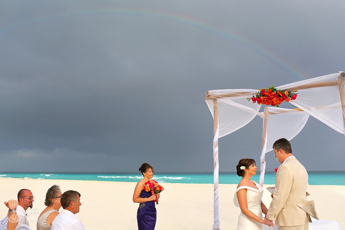 destination wedding on the beach at Iberostar cancun with rainbow