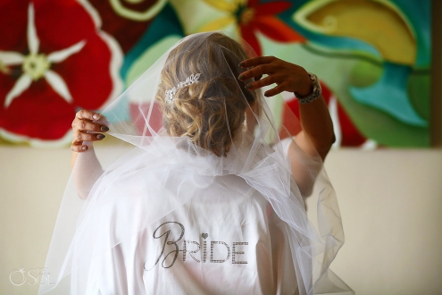bride wearing a robe with sequin letters spelling "Bride"