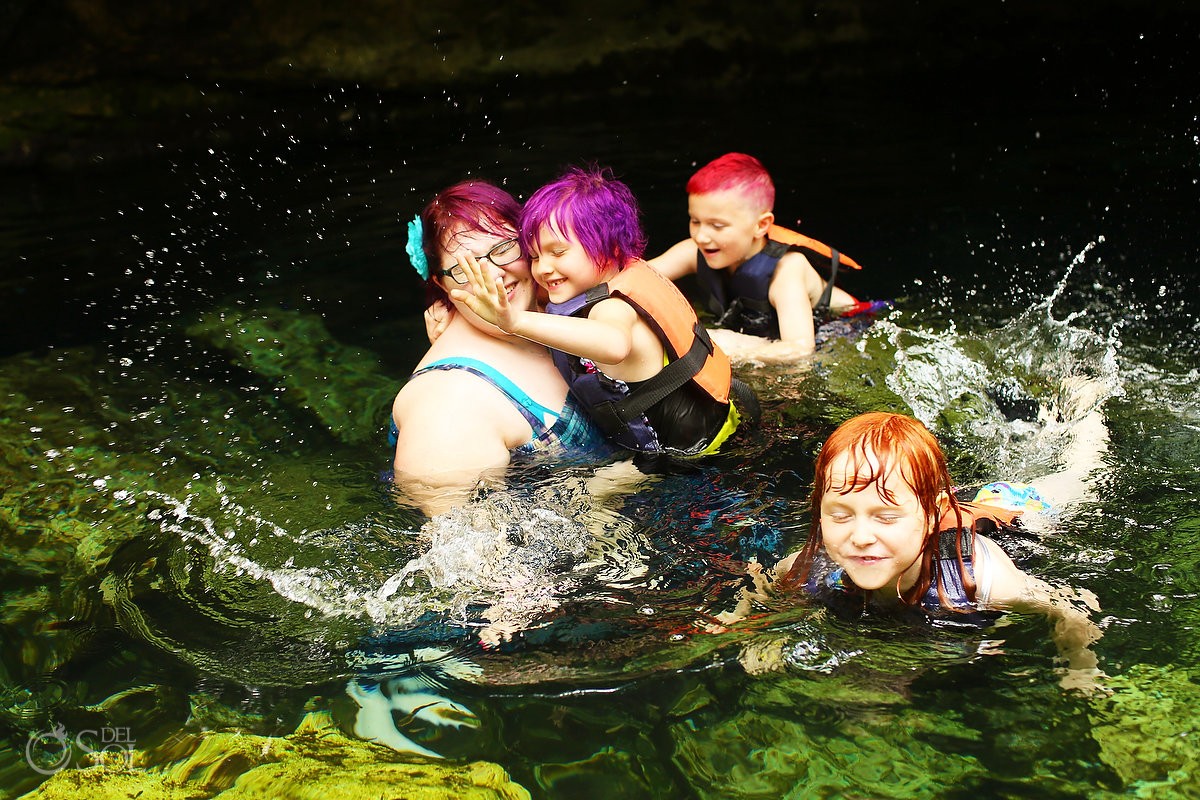 swimming in the mexican cenote with a family