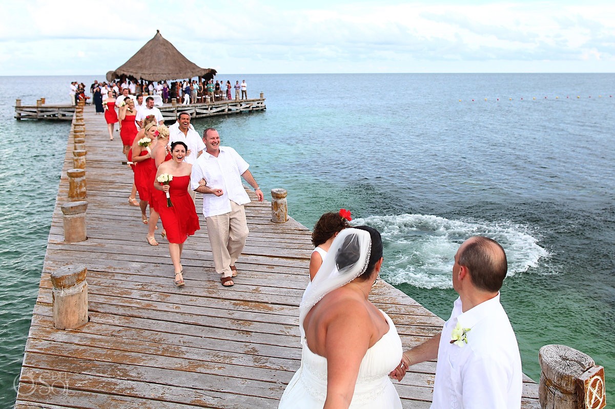 bride and groom iss guest jumps in water destination wedding photobomb