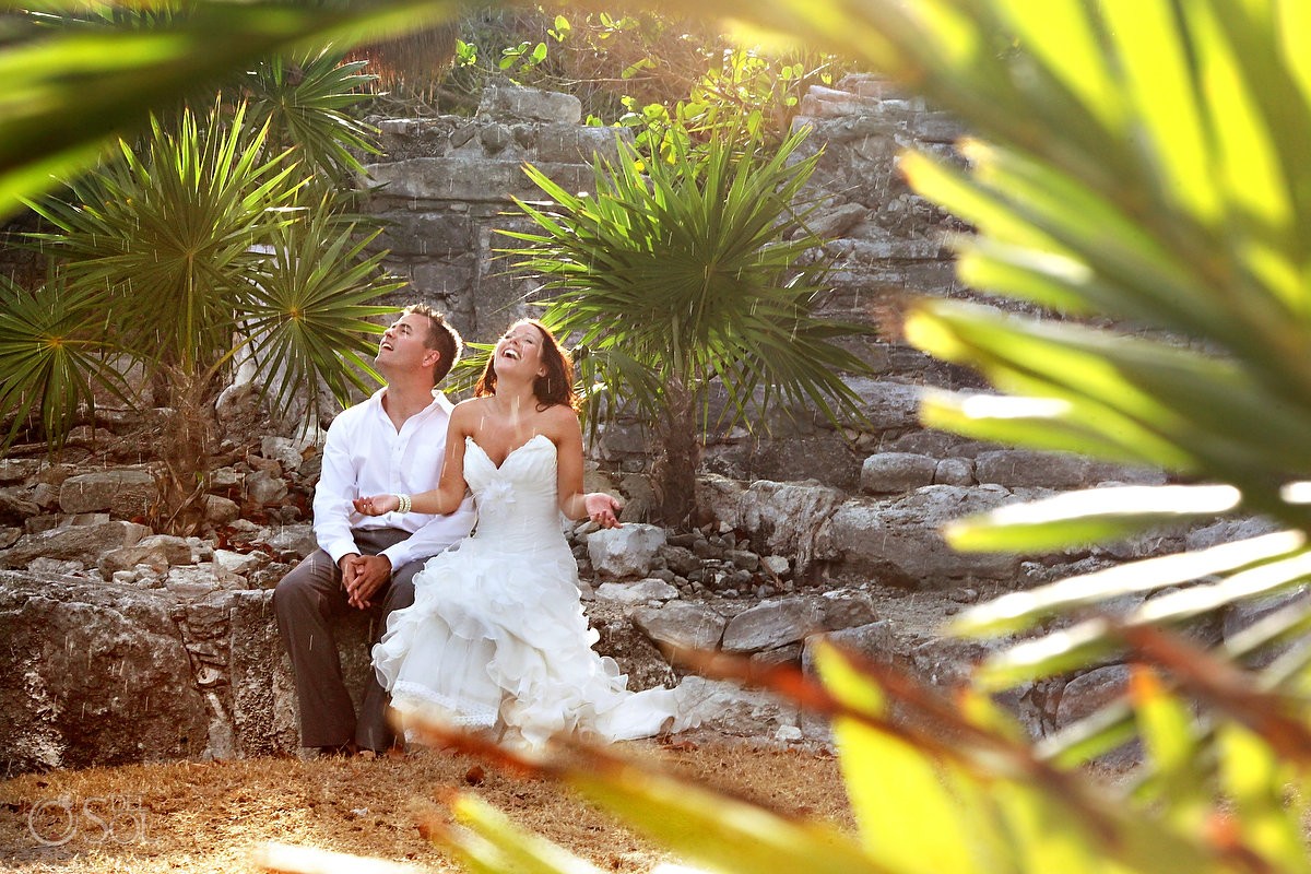 bride and groom under the rain in the mayan ruins in playa del carmen mexico