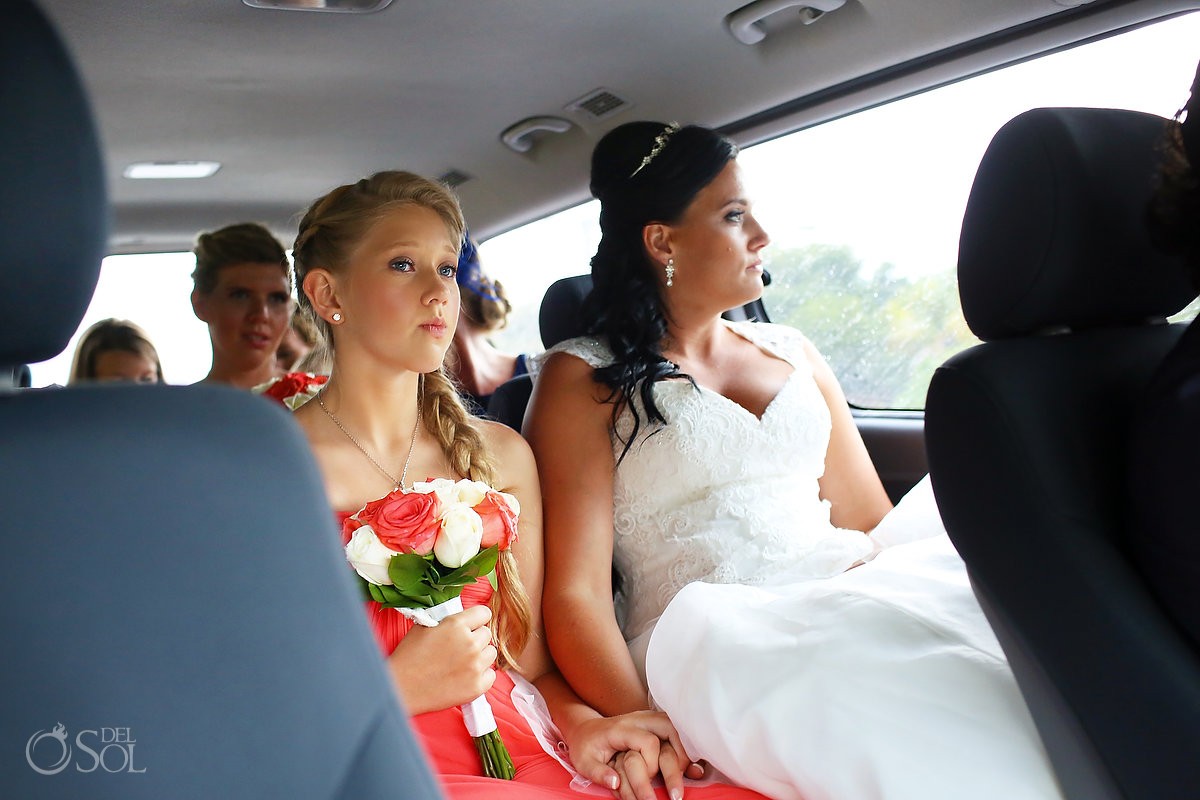 bride and bridesmaids arriving in a car on a rainy wedding day