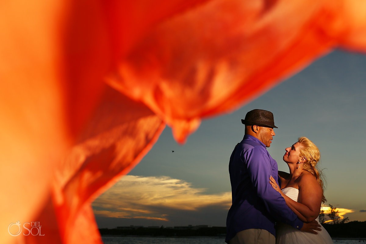 bride and groom portrait with sunset over playa del carmen