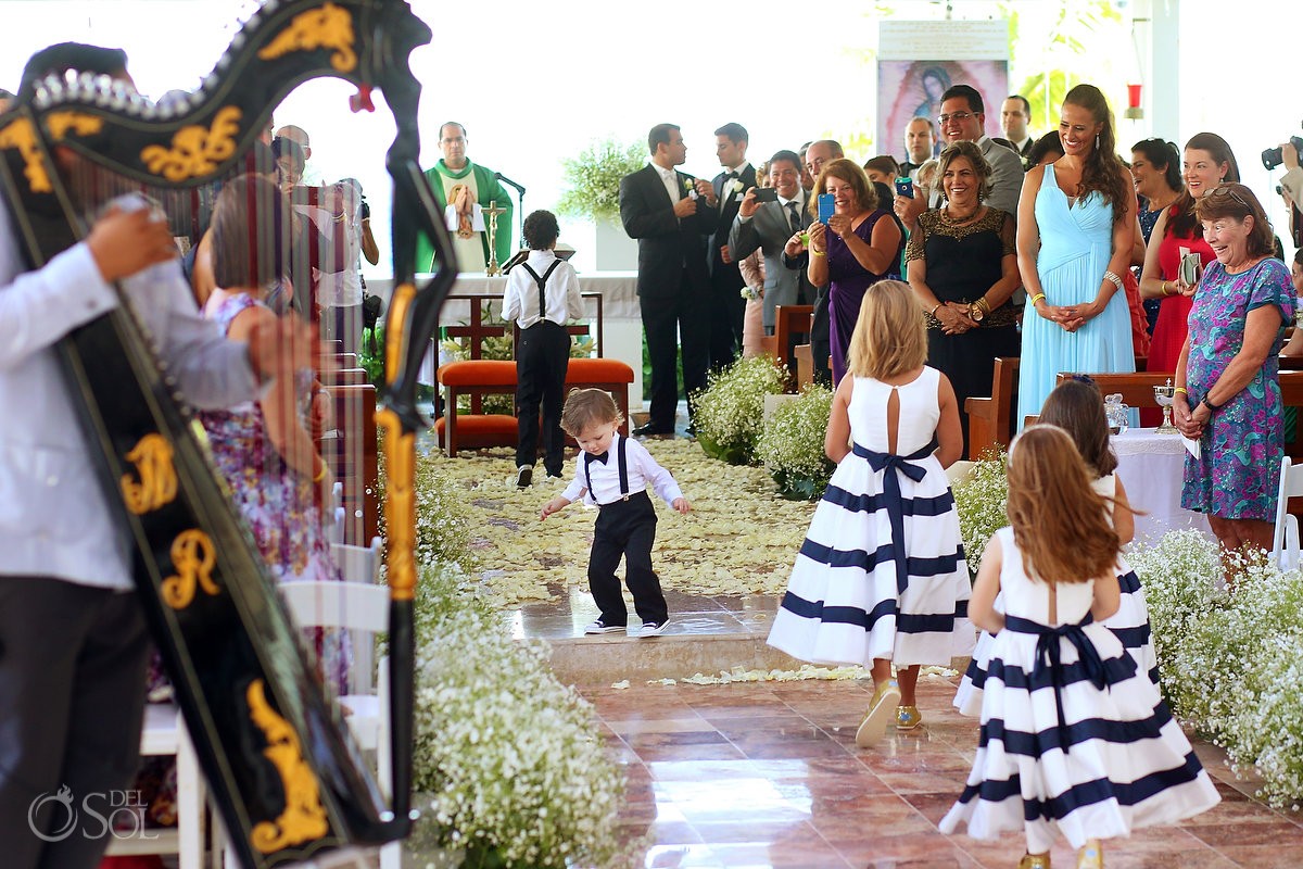 Cute kid ring bearer funny wedding picture lady Guadalupe Chapel Cancun