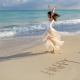 happy dancing, happiness written white sand beach, IntraAwareness Commercial shoot, portraits Isla Blanca, Cancun