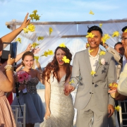 ceremony exit idea wedding guest throw bright yellow flowers confetti, just married, destination wedding Royalton Riviera Cancun, Mexico