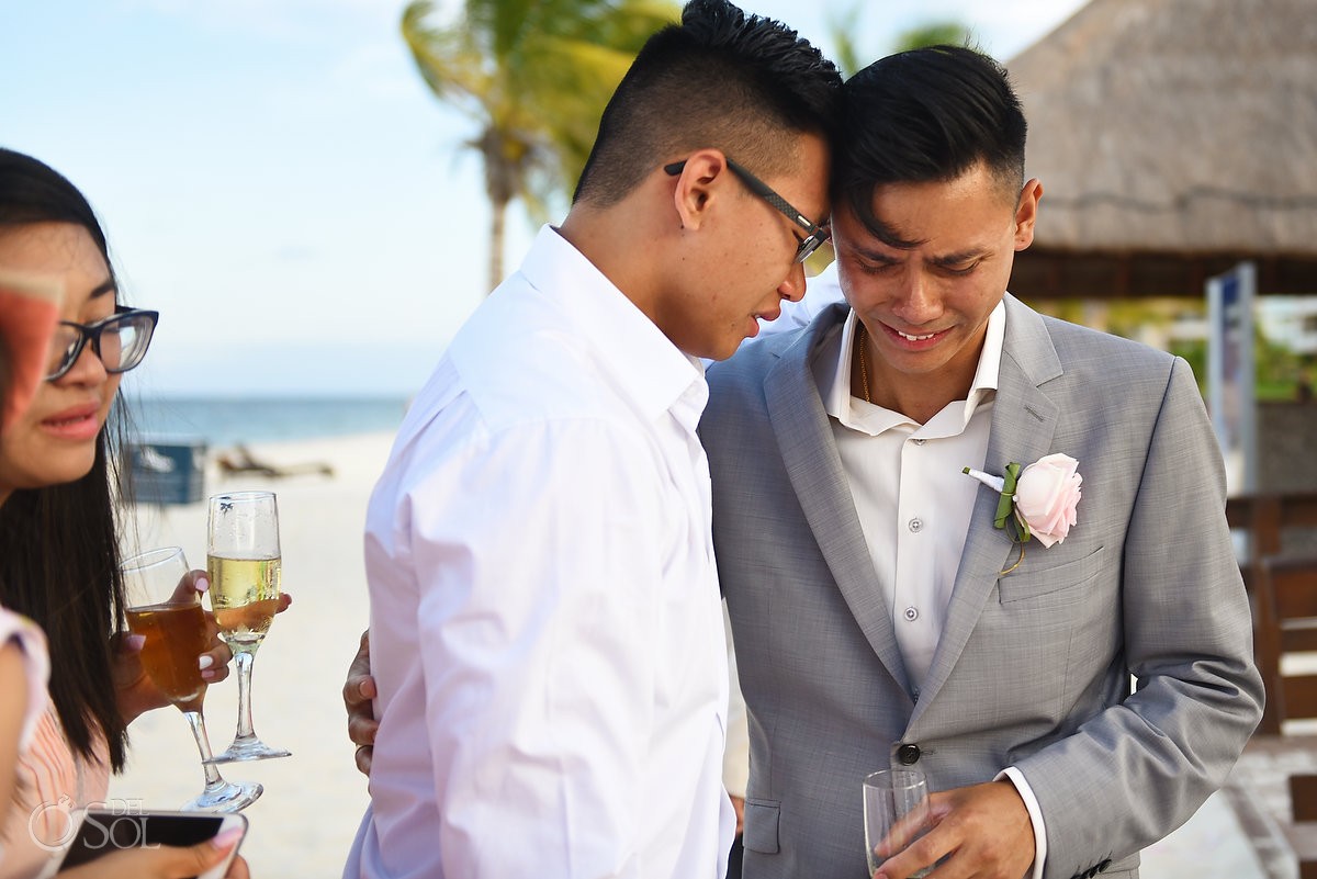 Groom and brother crying after wedding ceremony, Royalton Riviera Cancun, Mexico