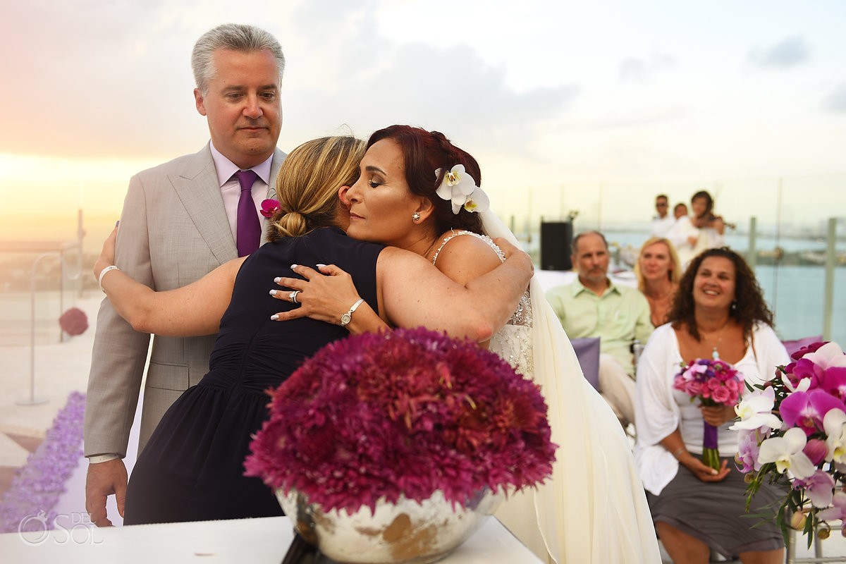 guest hugs wedding ceremony destination Beach Palace, Cancun, Mexico.