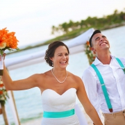 just married happy emotional bride and groom exit beach destination wedding ceremony Grand Sirenis Riviera Maya Mexico