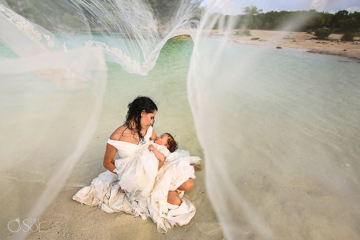 bride and baby framed by flying veil beach trash the dress Playa del Carmen Mexico
