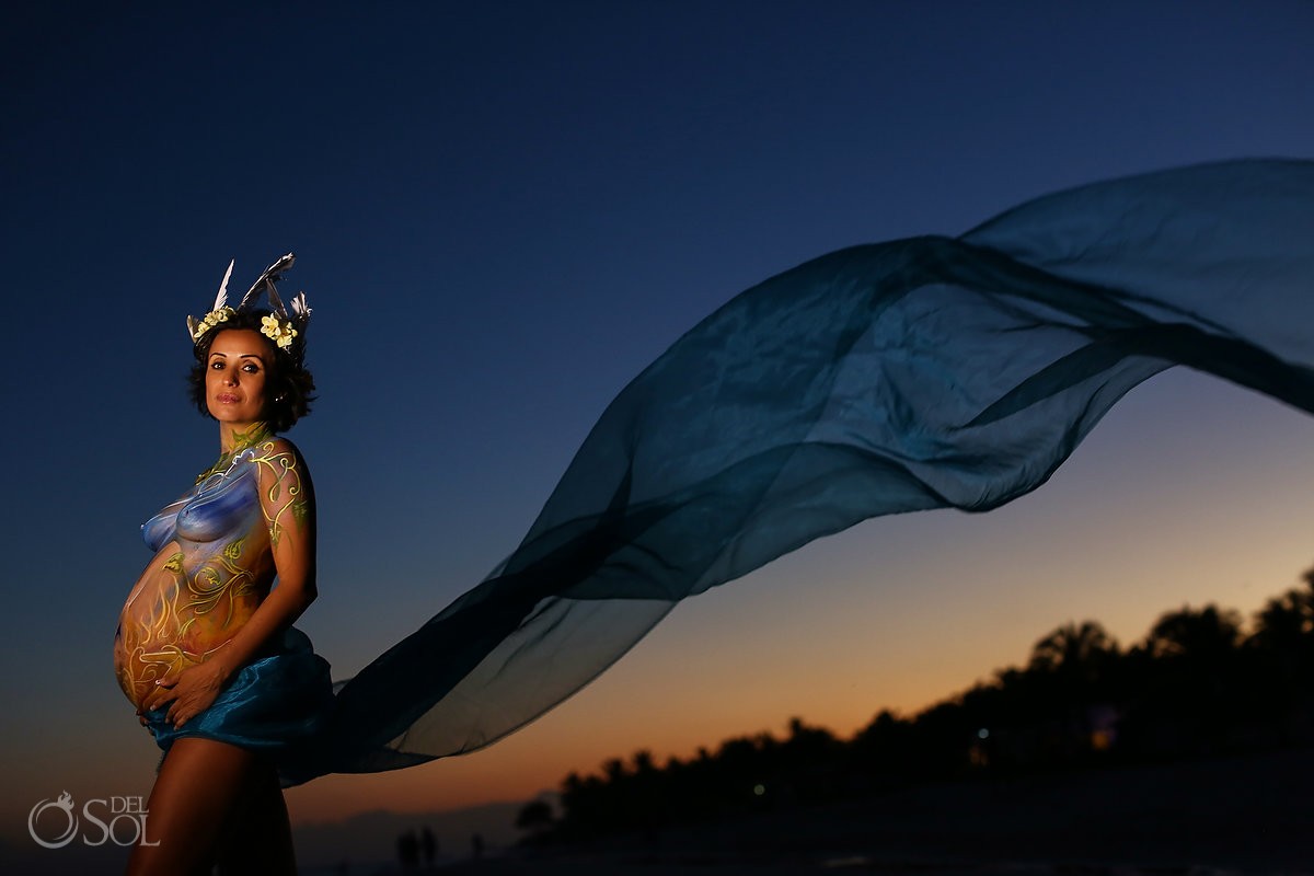 Air element pregnant mother maternity photoshoot body paint flowing fabrics beach sunset