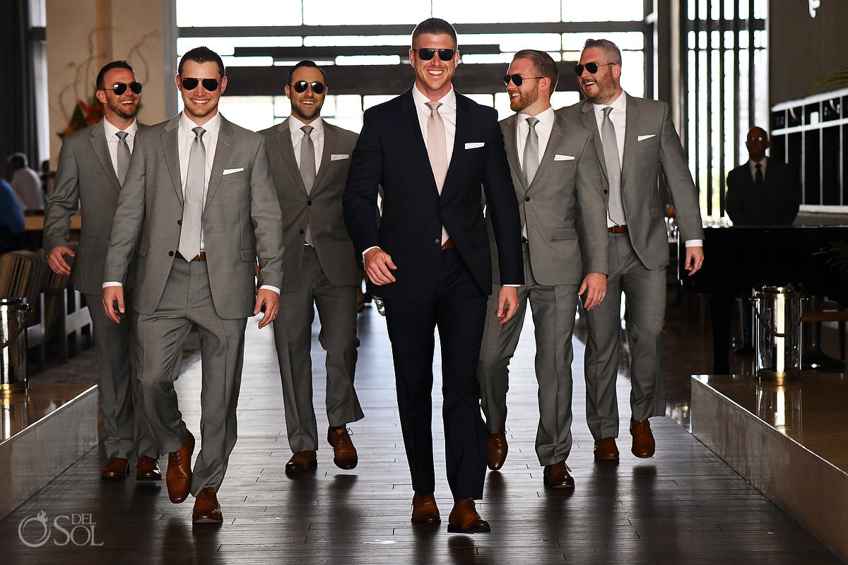 groom and groomsman walking close to get married Secrets the Vine AM Resorts Mexico.