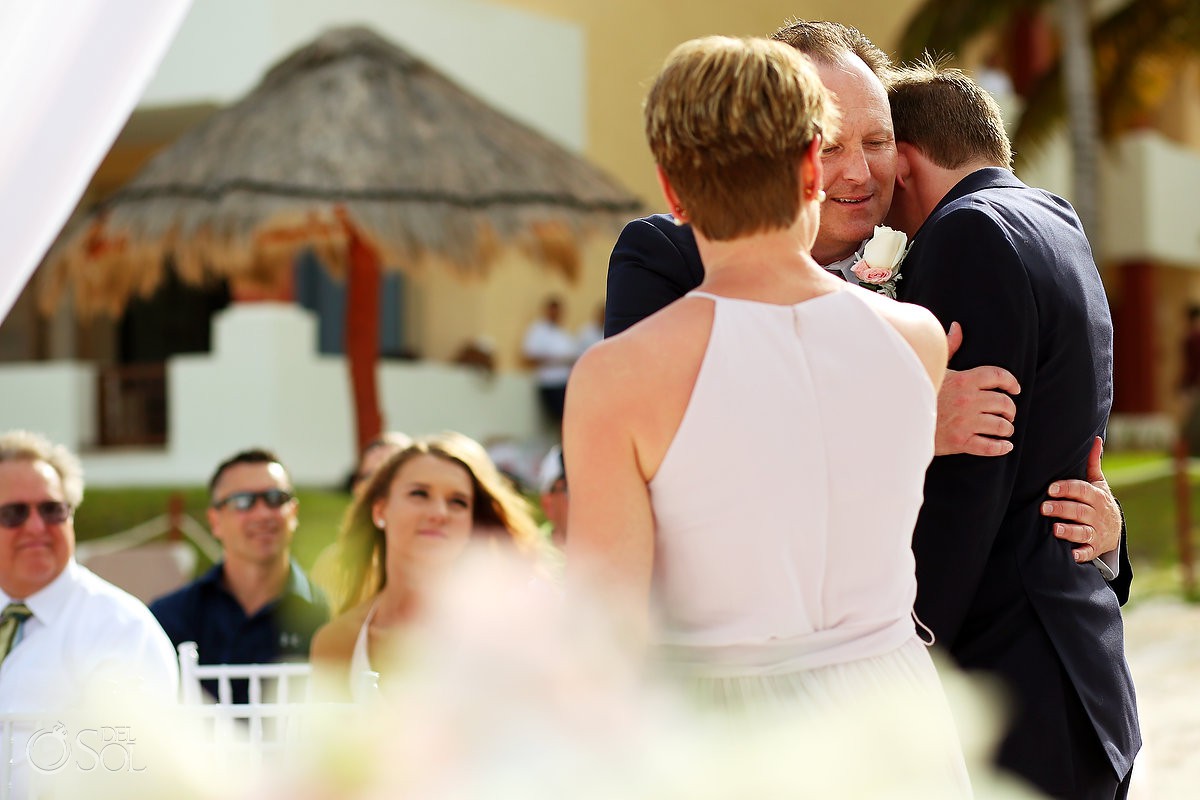father of groom hugs groom family love destination wedding Now Sapphire Riviera Cancun Mexico