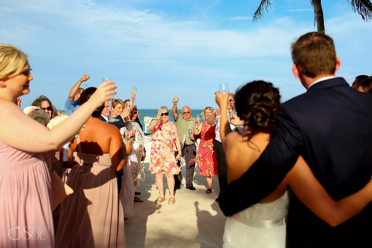 wedding guests toast newlyweds beach wedding Now Sapphire Riviera Cancun Mexico