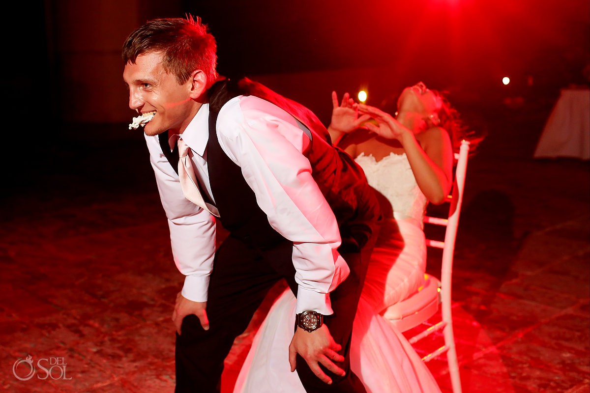 groom lap dances bride with garter in his mouth destination wedding reception Now Sapphire Riviera Cancun Mexico