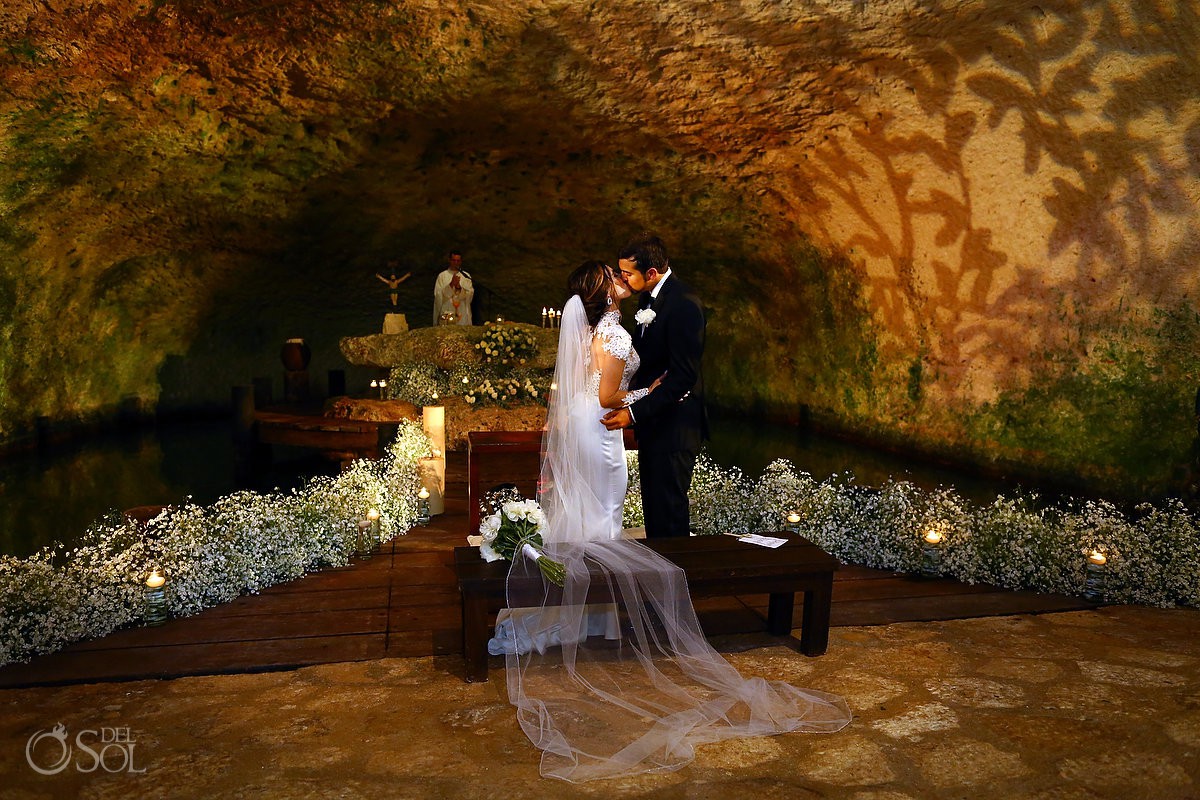 first kiss bride and groom just married Guadalupe Chapel Xcaret Park Riviera Maya Mexico