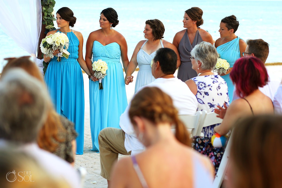 bridesmaids in long blue mismatched bridesmaids dresses watching gay wedding ceremony secrets Akumal Mexico