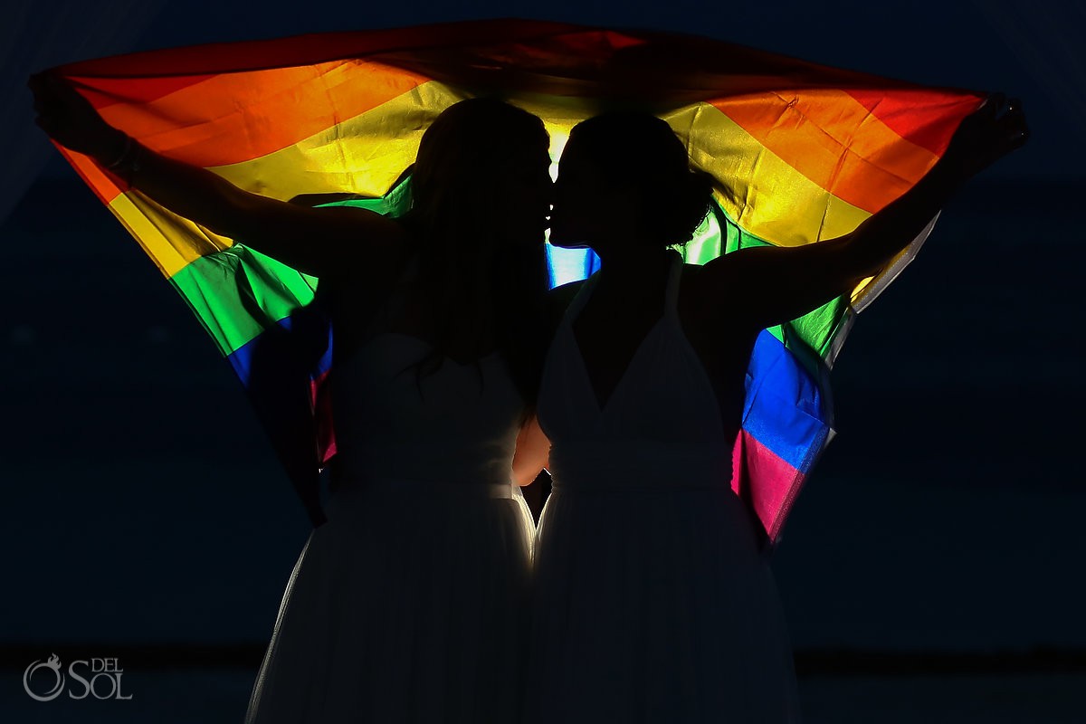 #loveislove same sex wedding bride and bride at secrets akumal riviera maya mexico rainbow flag gay portrait ideas