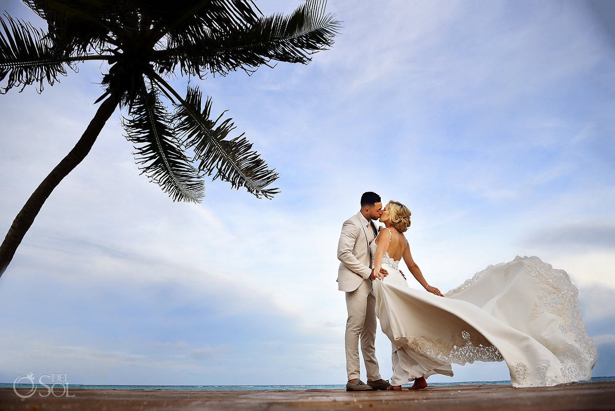 romantic destination wedding portrait on the beach under a palm tree dress blowing in the wind #TravelForLove