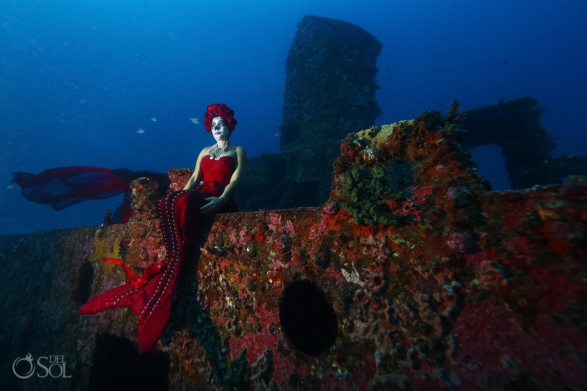 Iris Vasconez as Catrina Sirena sitting on shipwreck artificial reef conservation project