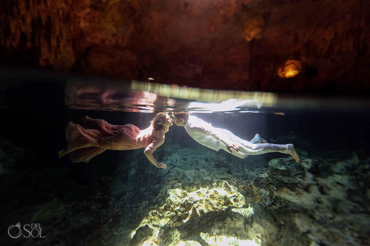 vow renewal Cenote Riviera Maya Mexico bride and groom swimming