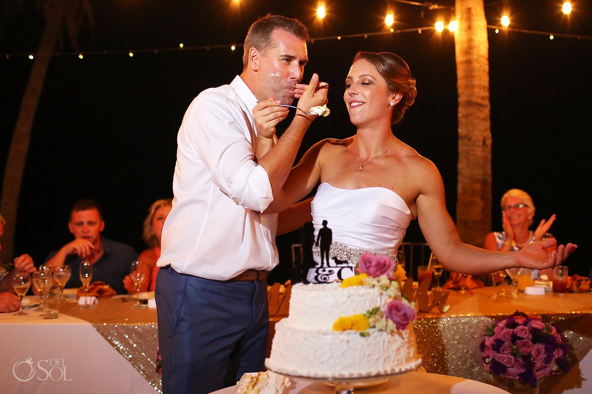 cake cutting bride and groom having fun Secrets Capri Riviera Cancun Playa del Carmen Mexico