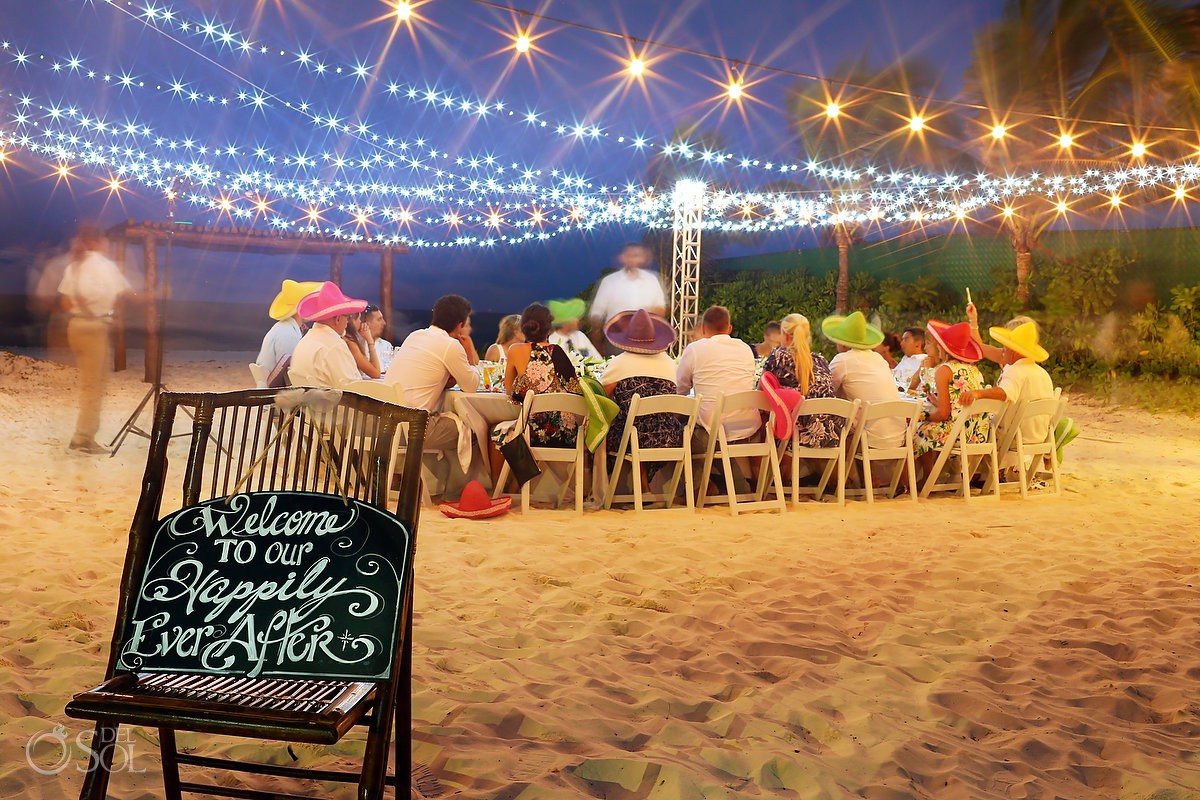 Welcome to our happily ever after sign Secrets Capri beach wedding reception fairy lights