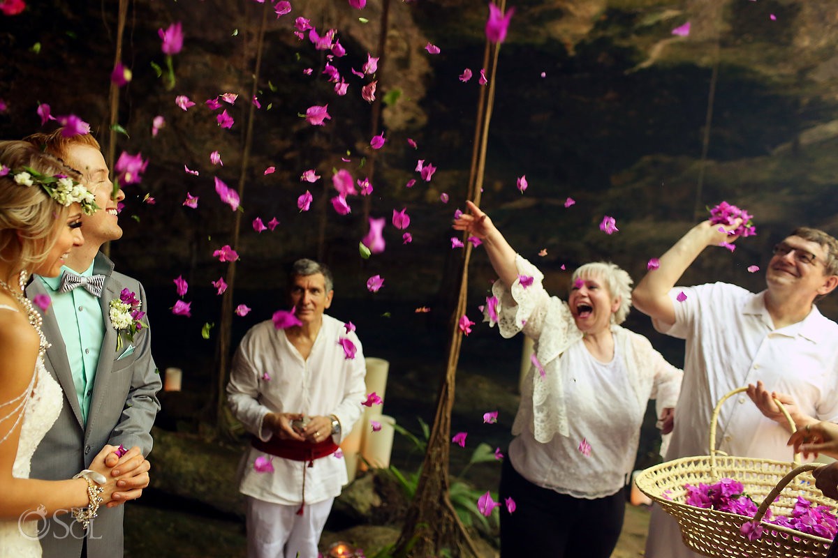blessing couple mom throwing flower petals cenote elopement Riviera Maya