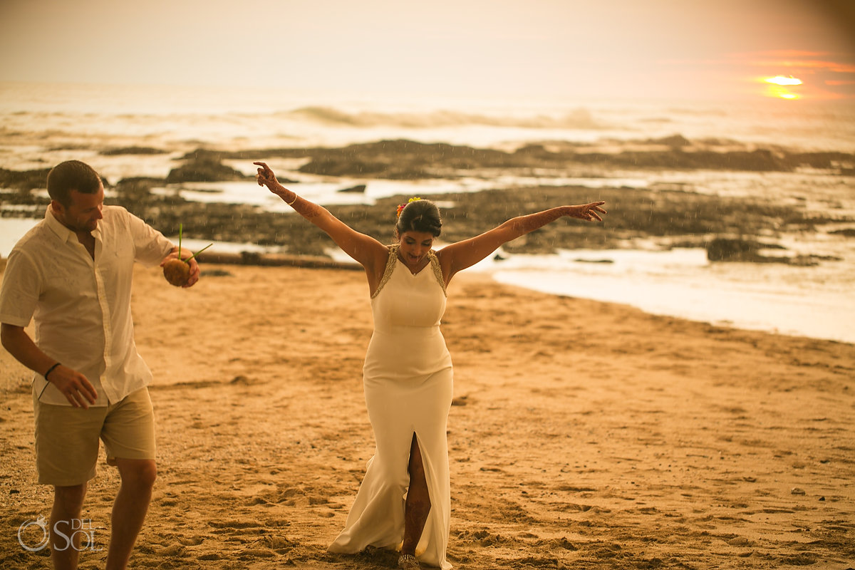 Bride and groom enjoying the rain sunset playa langosta Costa Rica