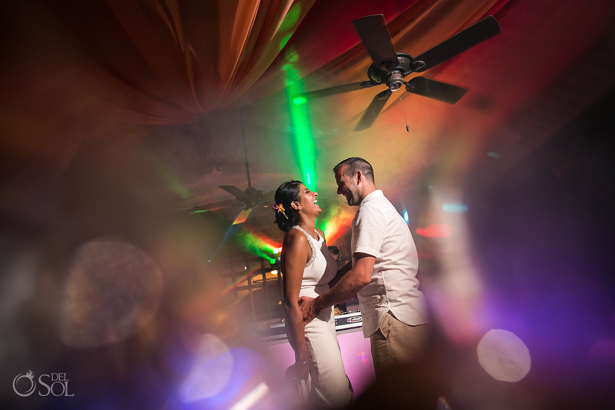 Bride and Groom dancing at the reception with colofour lights