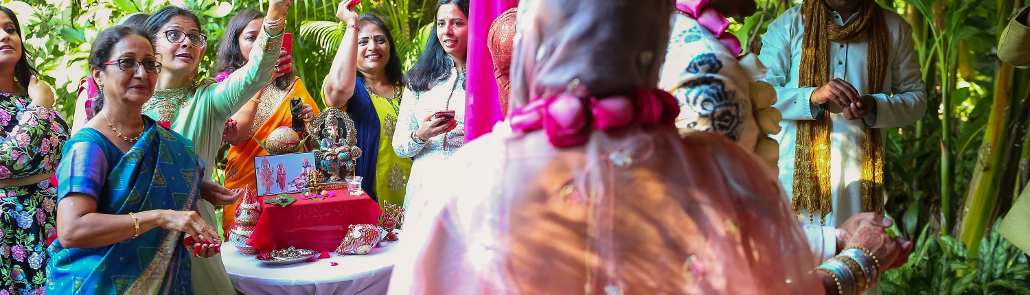 guest throwing flower petals Indian wedding ceremony