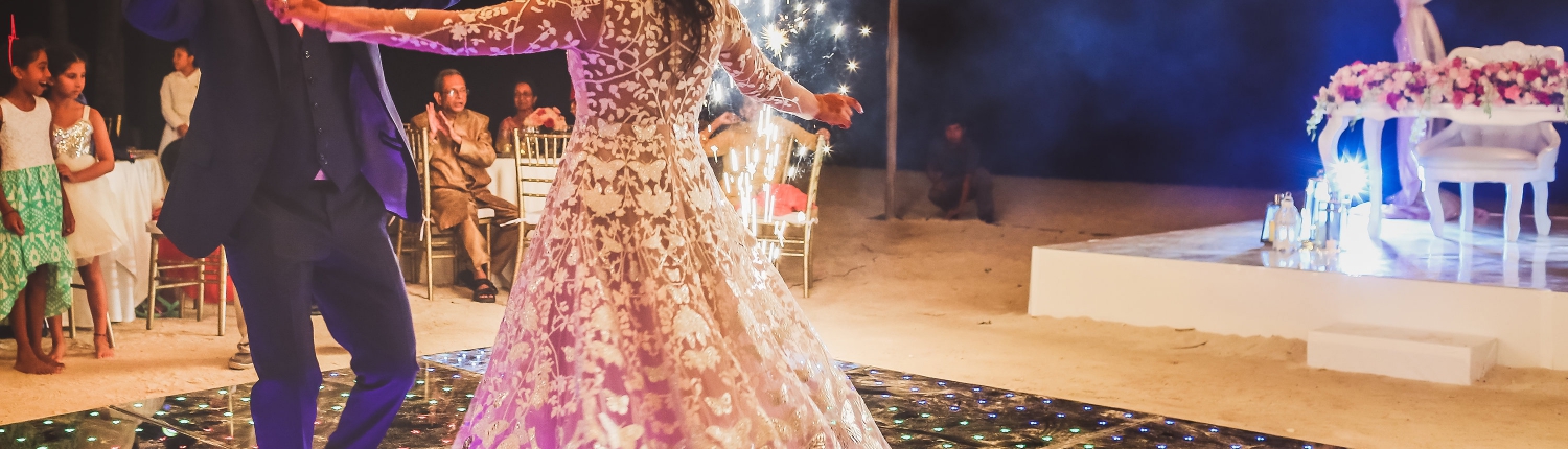 Bride and groom first dance between fireworks Dreams Tulum Indian wedding