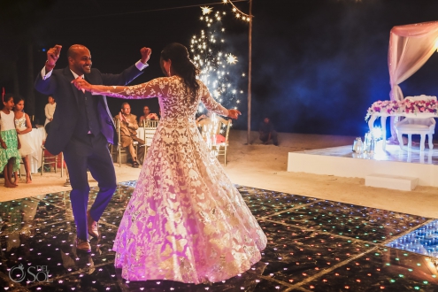Bride and groom first dance between fireworks Dreams Tulum Indian wedding