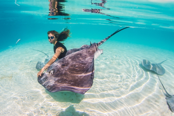 Catrina Makeup woman playing with stingray light reflections clear amazing water white sand Tahiti underwater photography