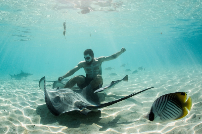 Catrina Makeup Men playing with stingray light reflections clear amazing water white sand Tahiti underwater photography