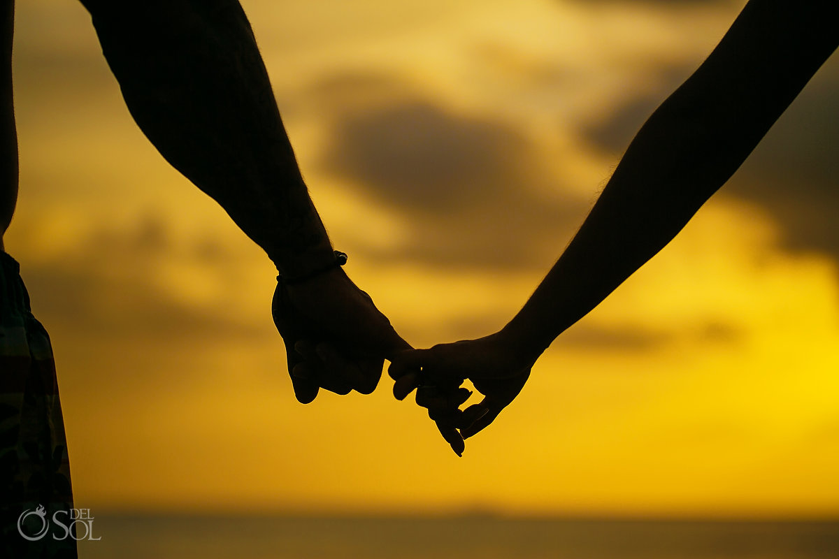 Dreams Las Mareas Beach Portrait session holding hands at sunset