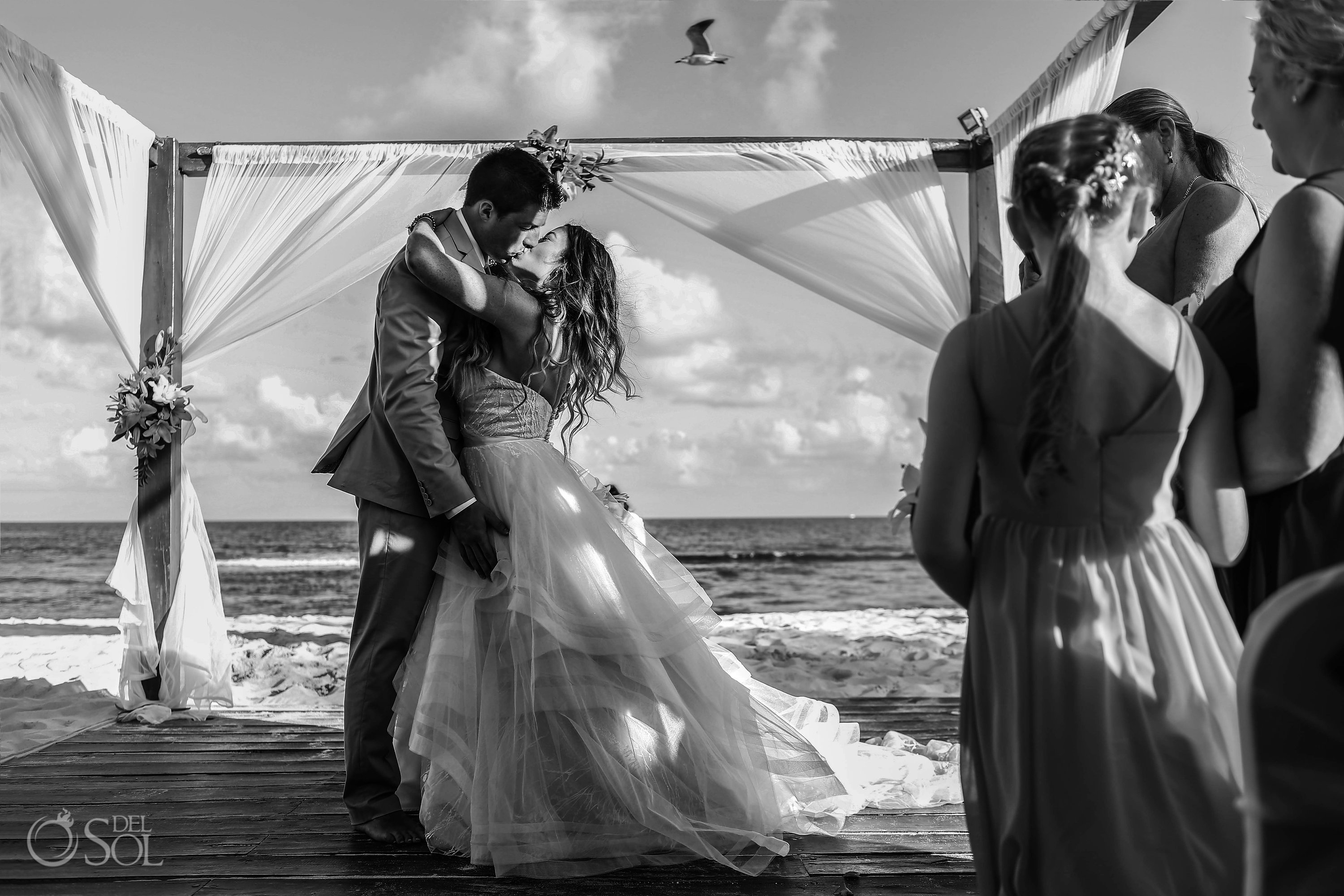 First kiss with bird flying overhead Iberostar Paraiso del Mar Wedding Cancun