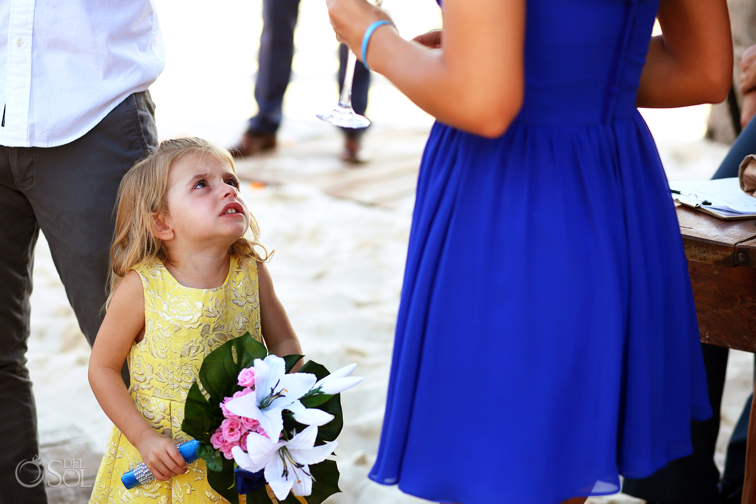 Funny wedding photo, little girl looking angry holding bridesmaid's bouquet Iberostar Paraiso del Mar Wedding