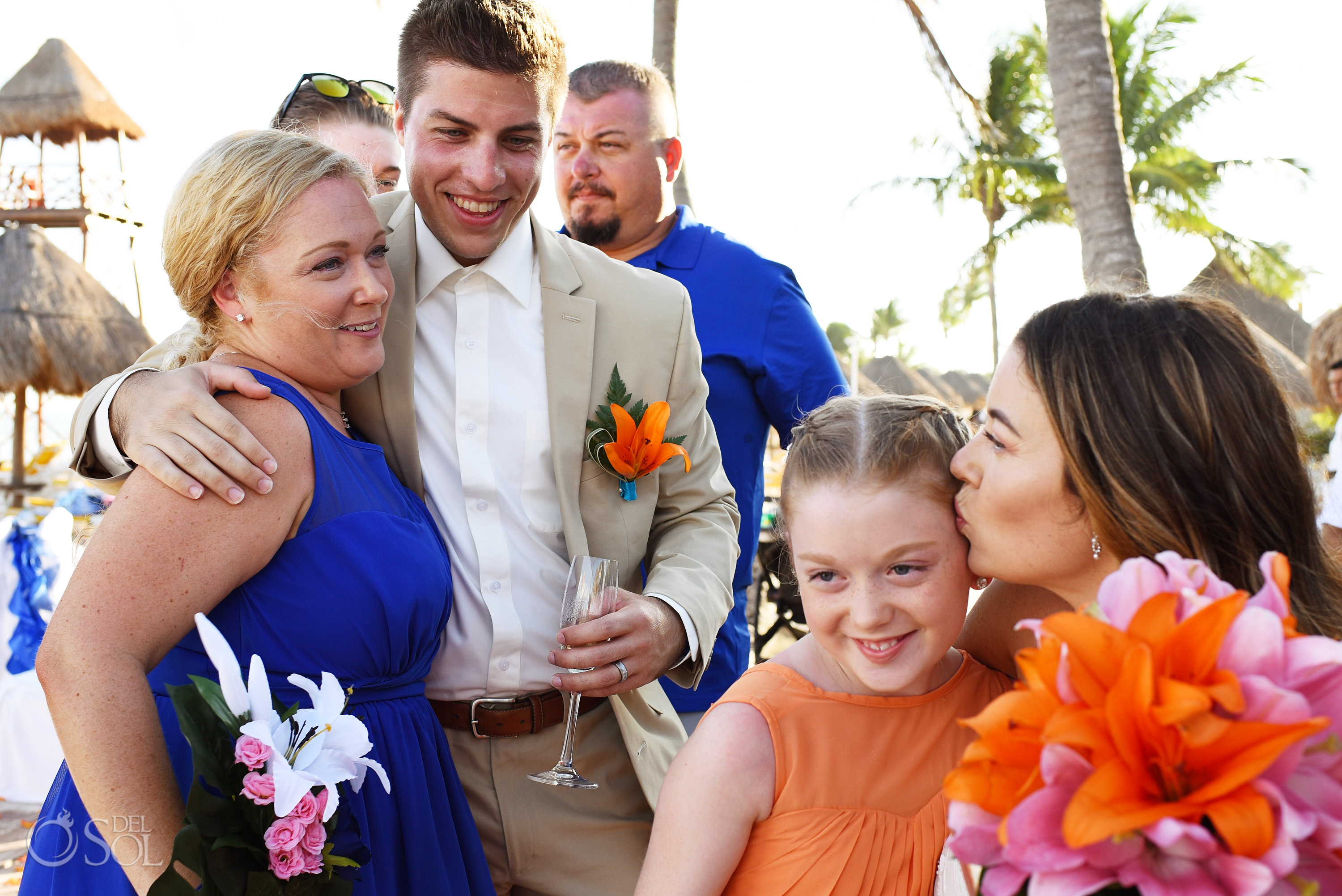 family love groom hugging bridesmaid and bride kissing flower girl after ceremony Iberostar Paraiso del Mar Wedding